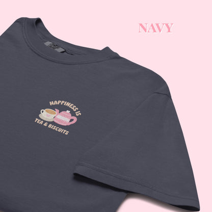 Navy t-shirt with 'Happiness is Tea & Biscuits' design on a pink background