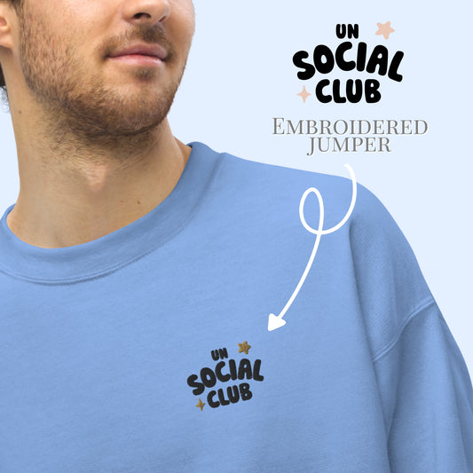 Blue sweater with 'UN SOCIAL CLUB' embroidery on a light blue background