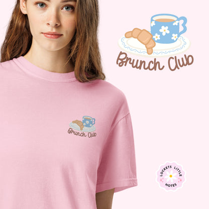 Women wearing a pink t-shirt with 'Brunch Club' embroidered design, featuring a coffee cup and croissant illustration. Cafe slow life cozy girl