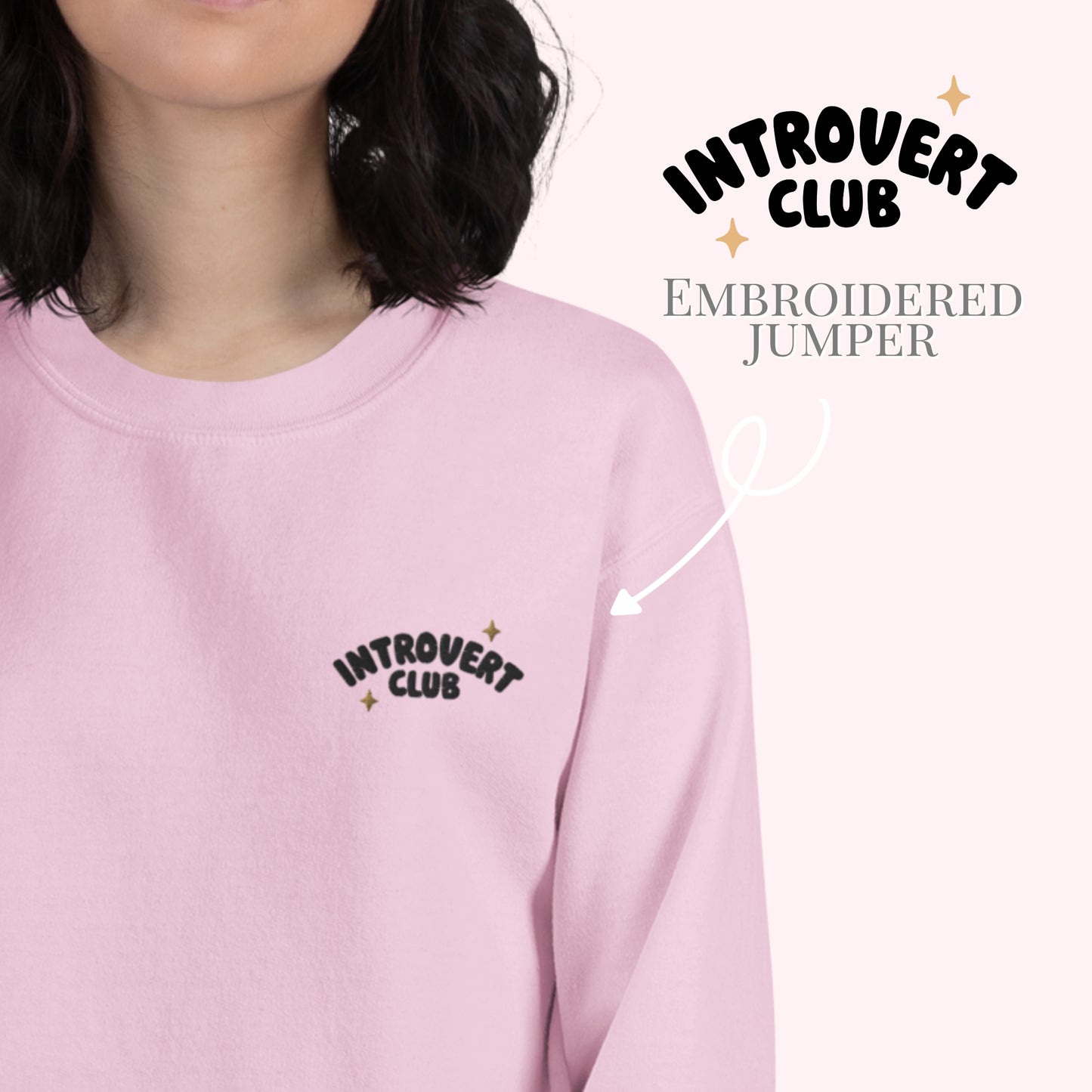 pink jumper worn by a woman with introvert club embroidered logo to the left chest. 