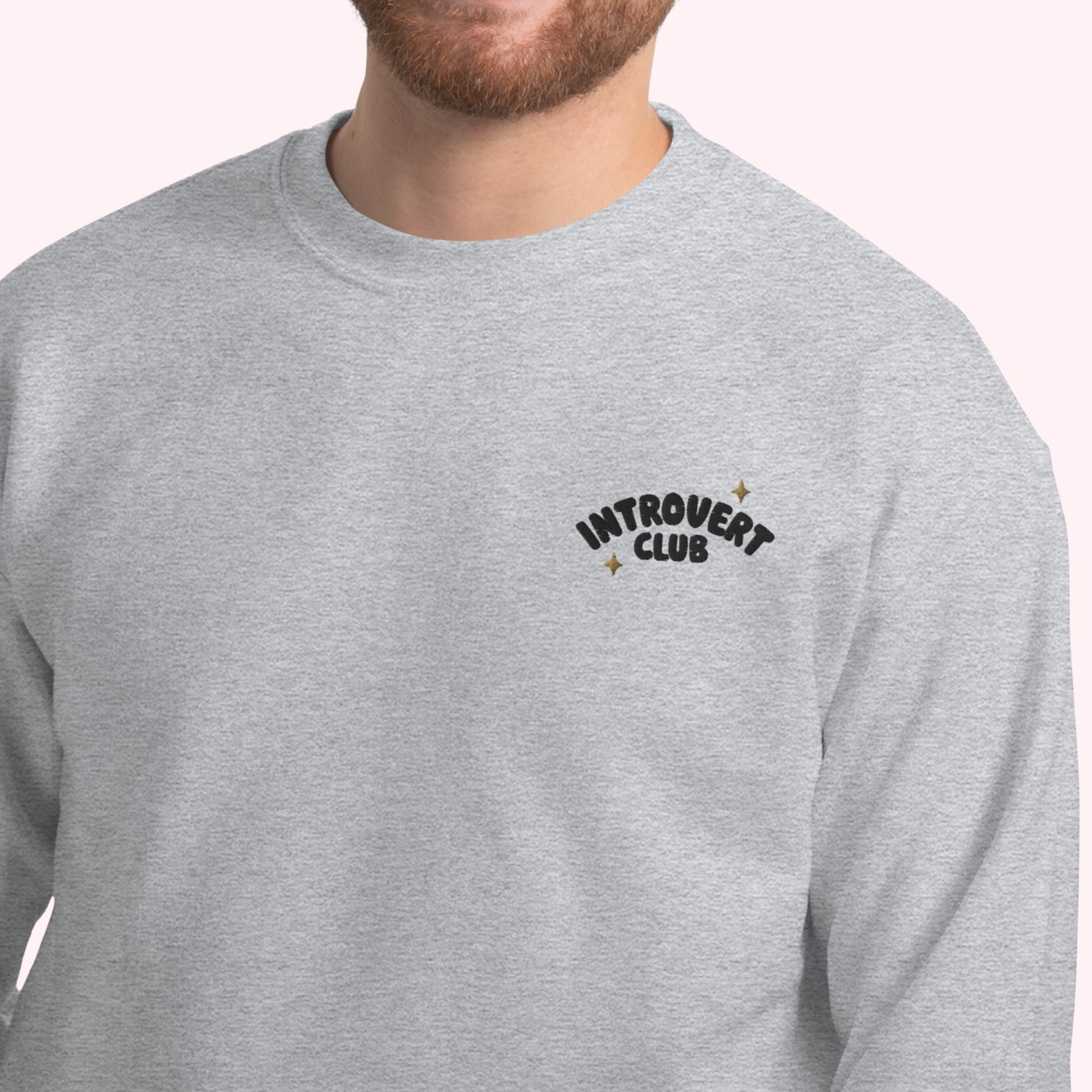 Grey sweatshirt with 'Introvert Club' text on a white background