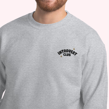 Grey sweatshirt with 'Introvert Club' text on a white background