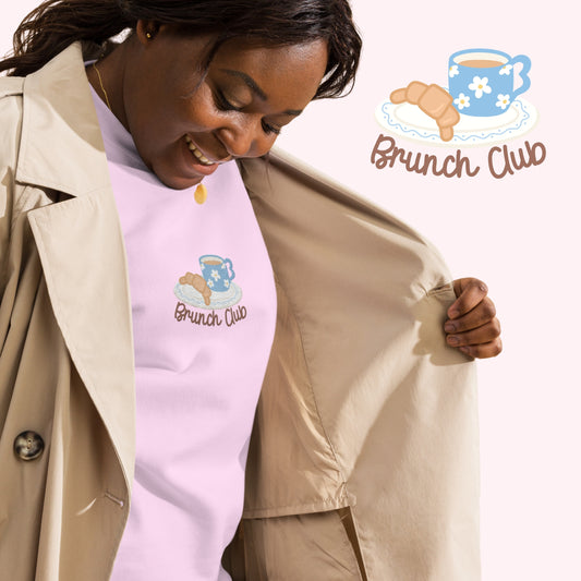 women wearing a pink sweatshirt with 'Brunch Club' design cozy croissant jumper. 