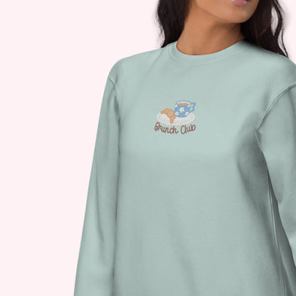 Light green sweatshirt with 'Brunch Club' embroidery on a white background. cozy girl slow life aesthetic