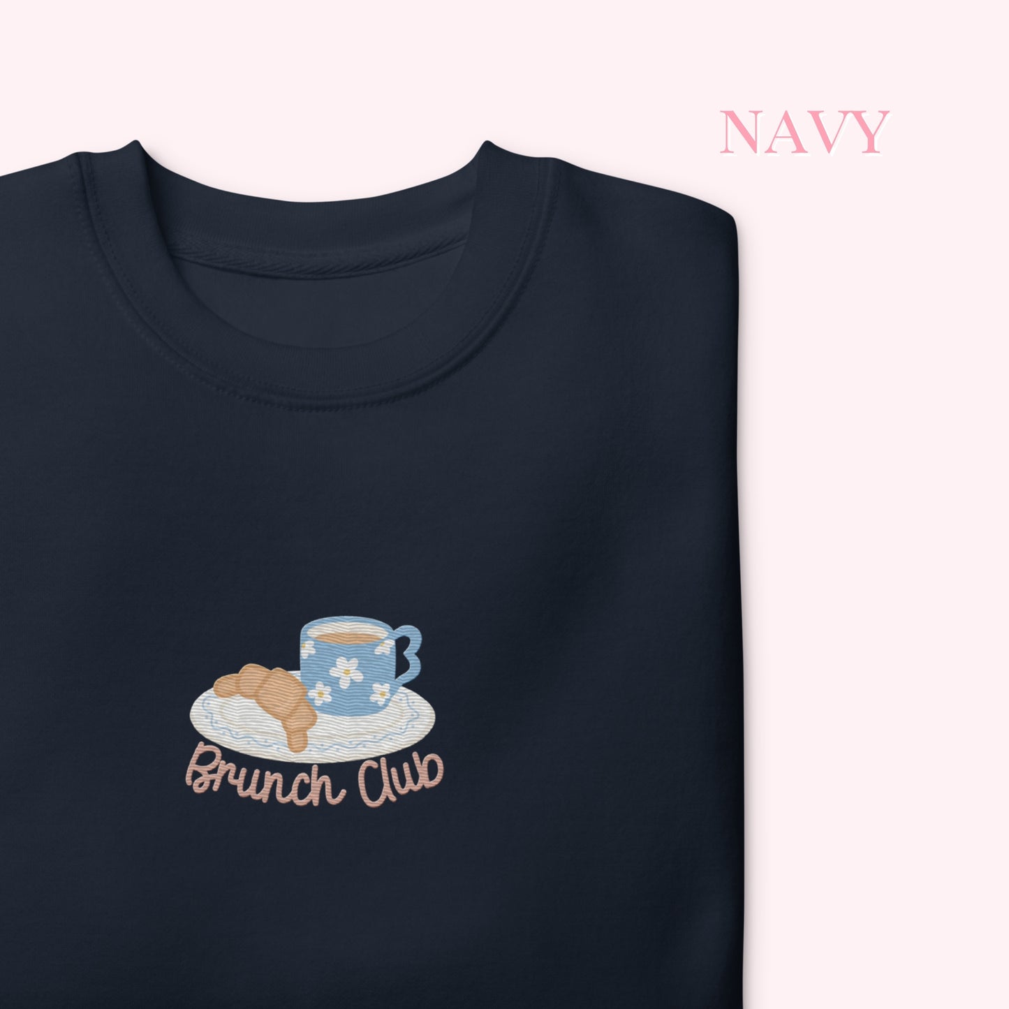 Navy sweatshirt with 'Brunch Club' design featuring a coffee cup and croissant on a white background.