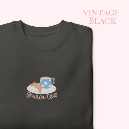 Black sweatshirt with 'Brunch Club' design featuring a coffee cup and croissant on a white background.