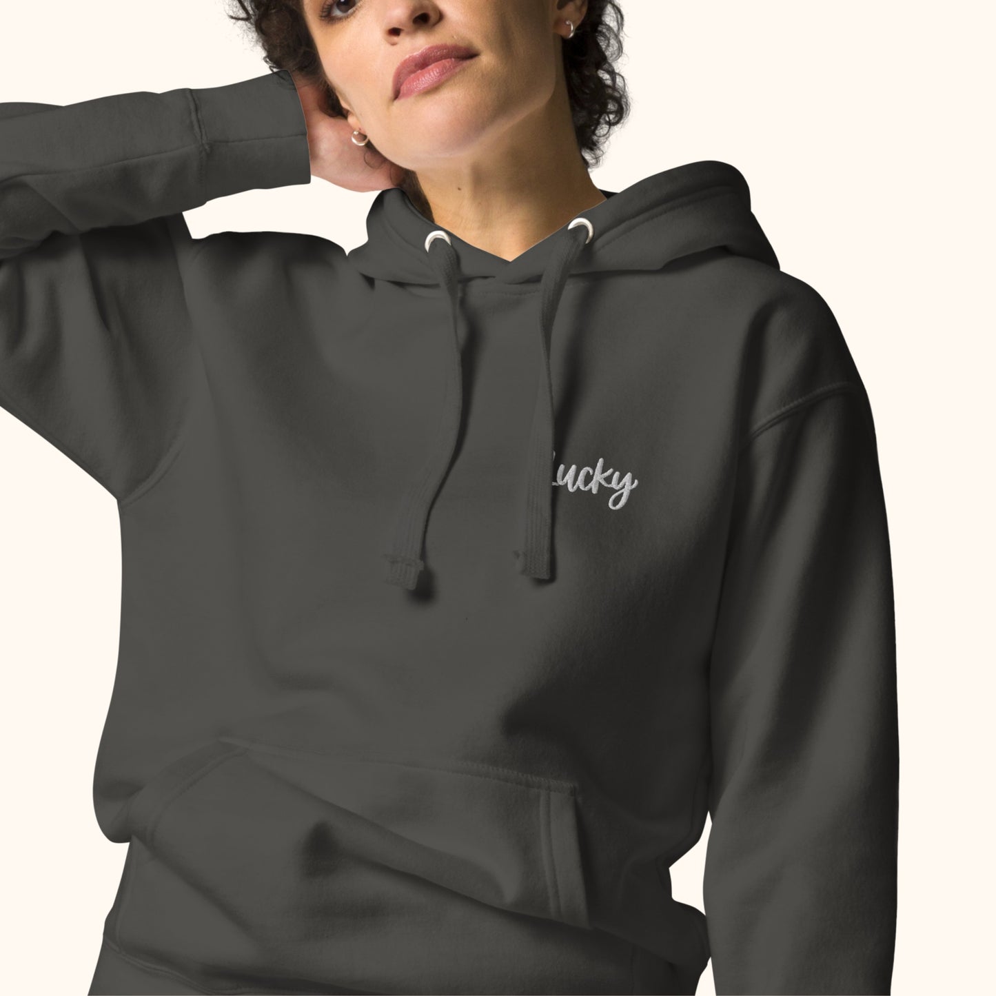 women wearing a hoodie with embroidered 'lucky' text on a white background