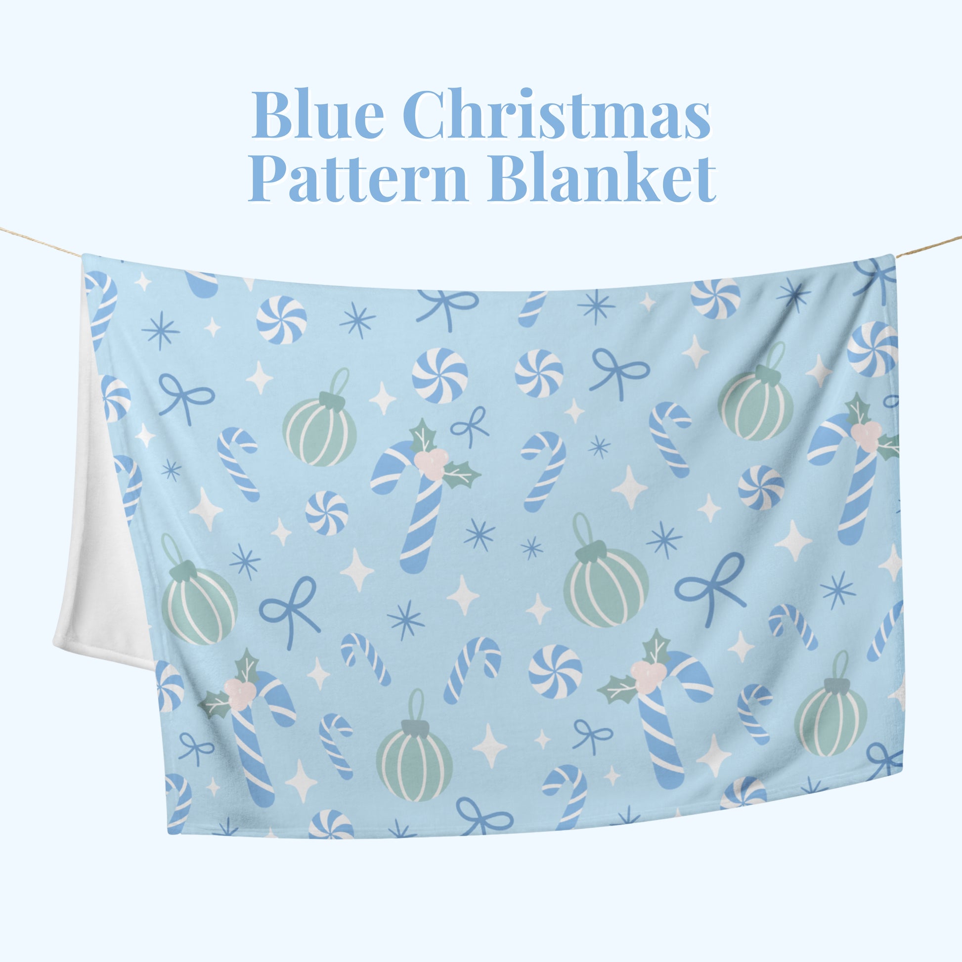 Blue Christmas pattern blanket with candy cane, bow, and star design on a white background.