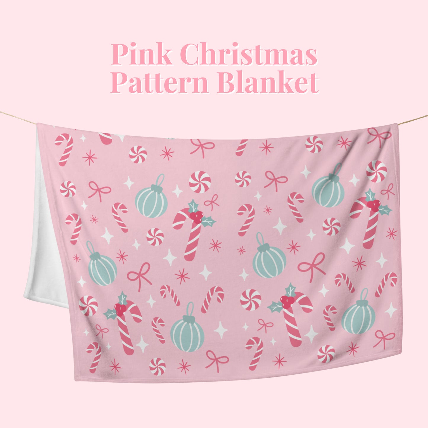 Pink Christmas pattern blanket with candy cane and bow design on a white background