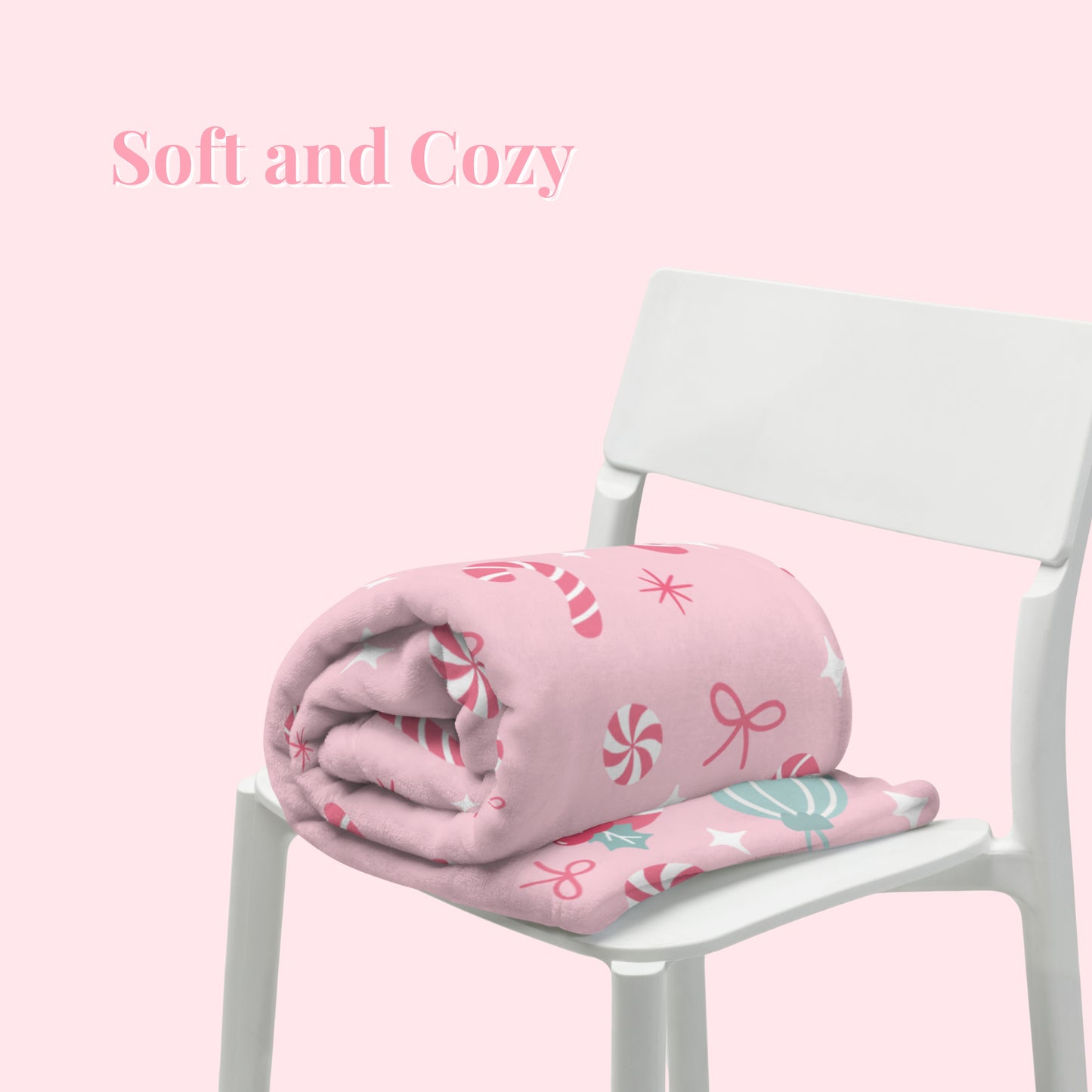 Pink Christmas blanket with candy cane pattern on a white chair against a pink background