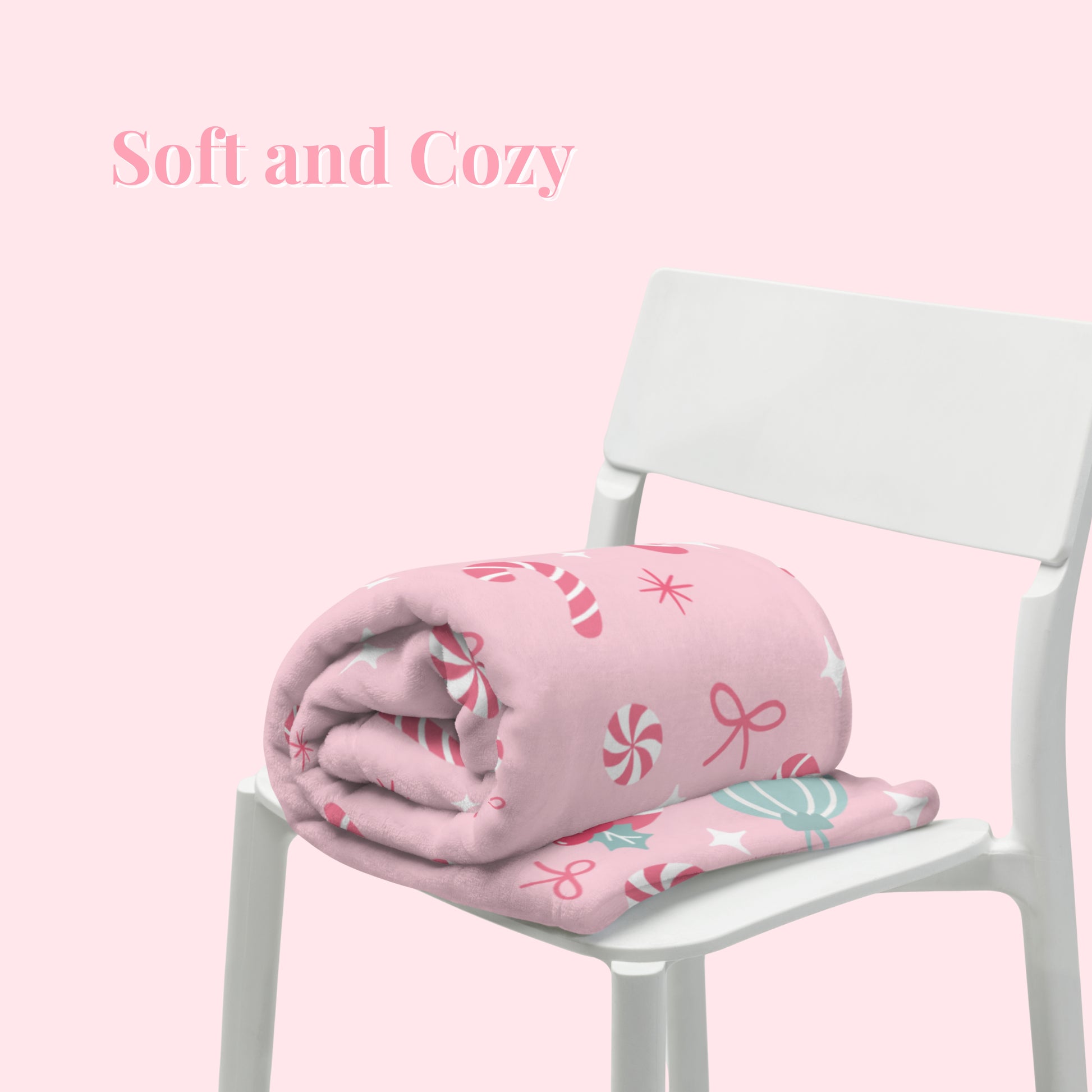 Pink Christmas blanket with candy cane pattern on a white chair against a pink background