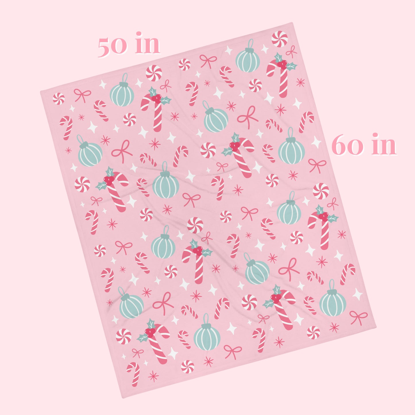 Pink decorative blanket with Christmas-themed patterns and measurements on a white background