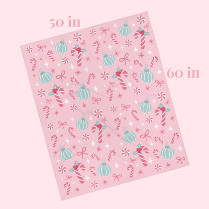 Pink decorative blanket with Christmas-themed patterns and measurements on a white background