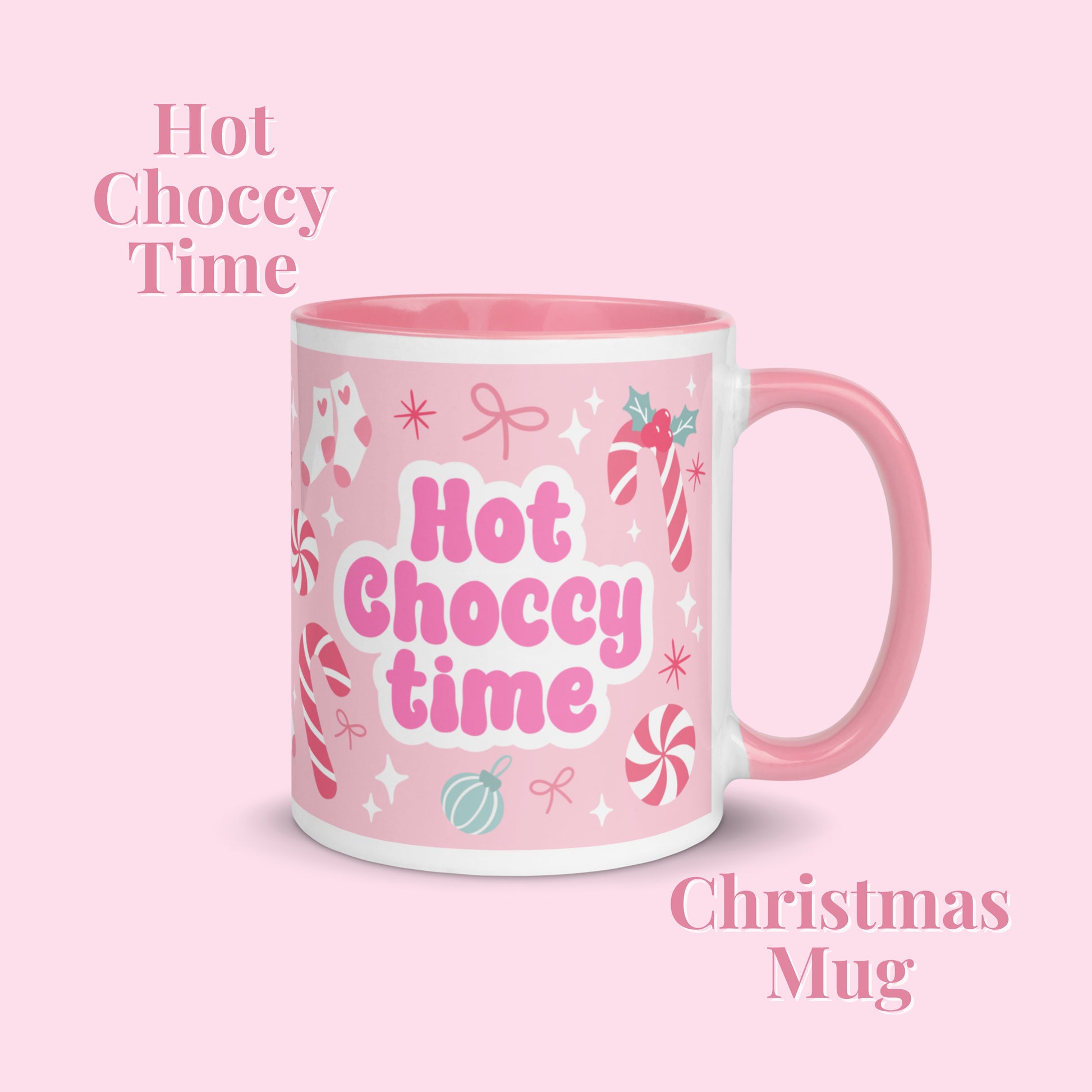 Pink mug with christmas pattern and a Hot choccy time motif on a light pink background