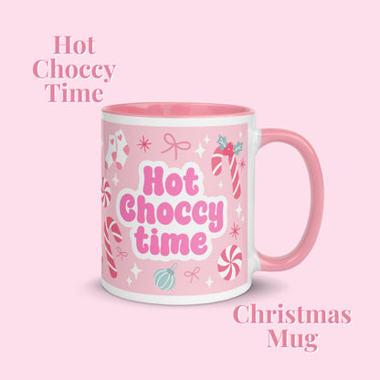 Pink mug with christmas pattern and a Hot choccy time motif on a light pink background
