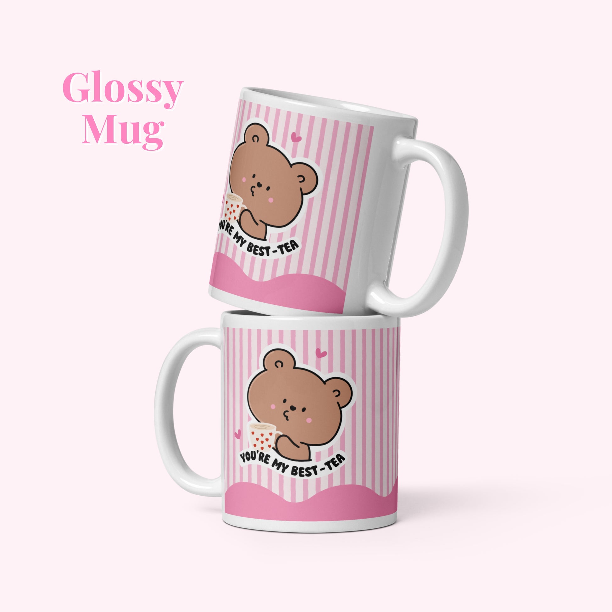Two pink mugs with bear illustrations and text on a white background