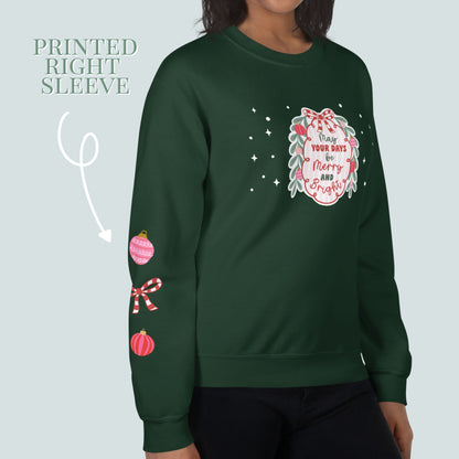 Green sweatshirt with festive designs on sleeves and front, on a light green background.