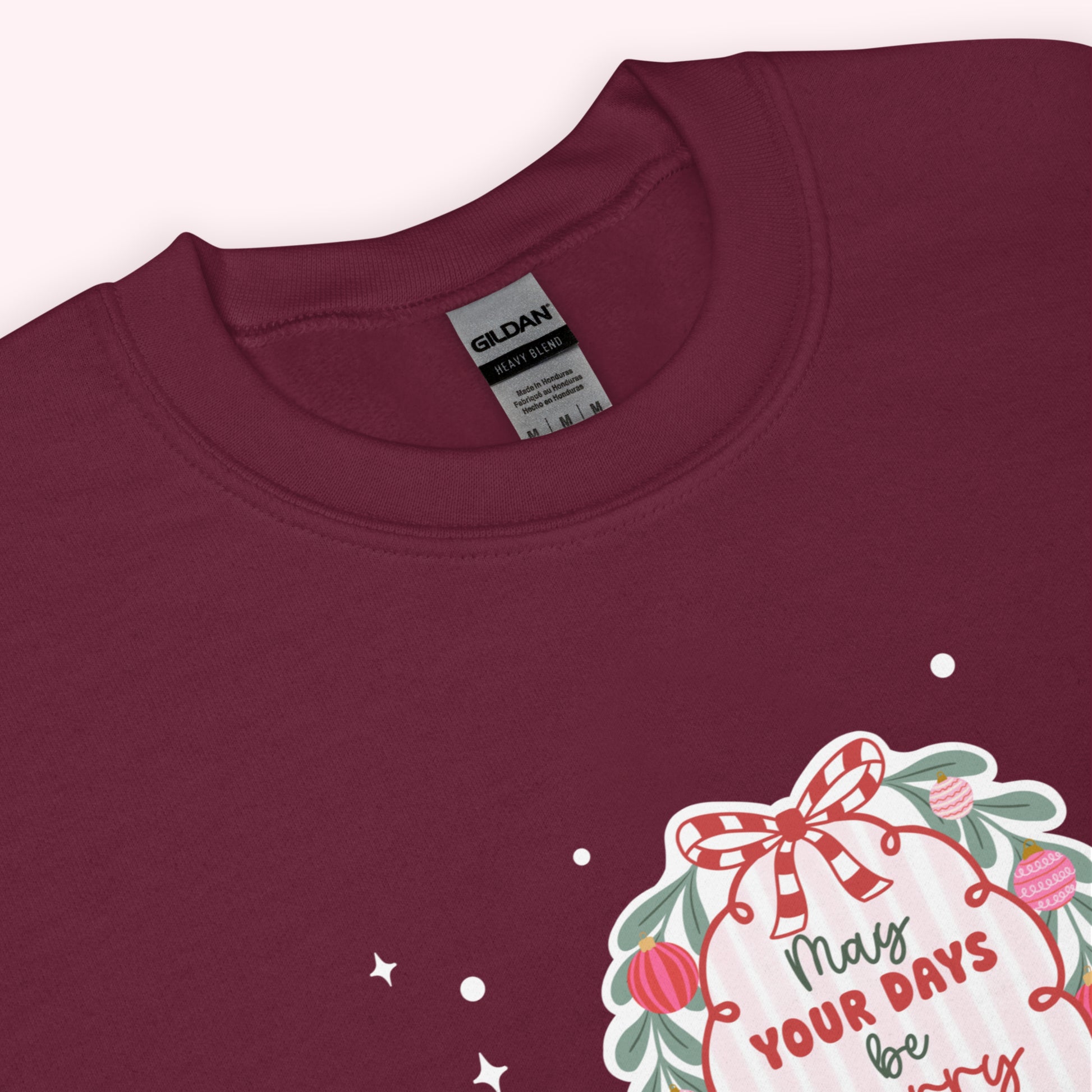 Maroon sweatshirt with a christmas graphic and 'Gildan' label on a white background