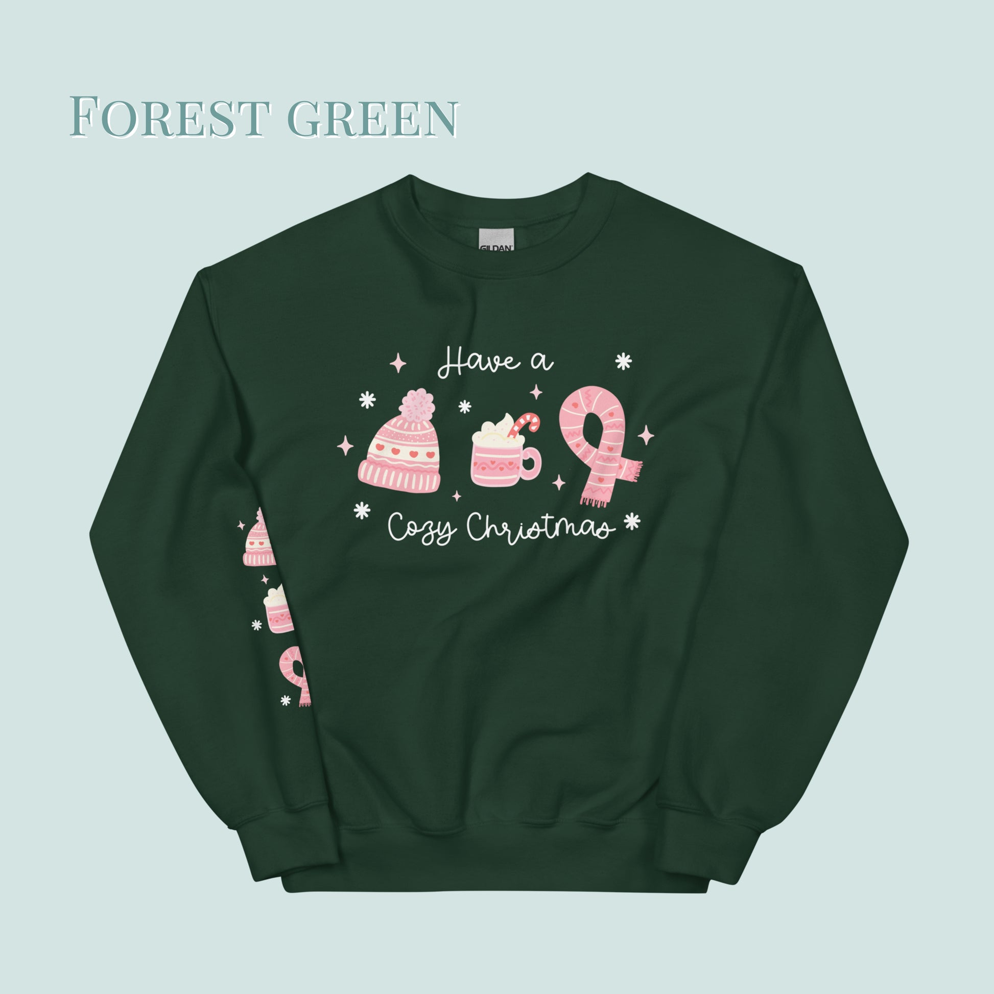 Forest green sweatshirt with pink Christmas-themed graphics on a light green background