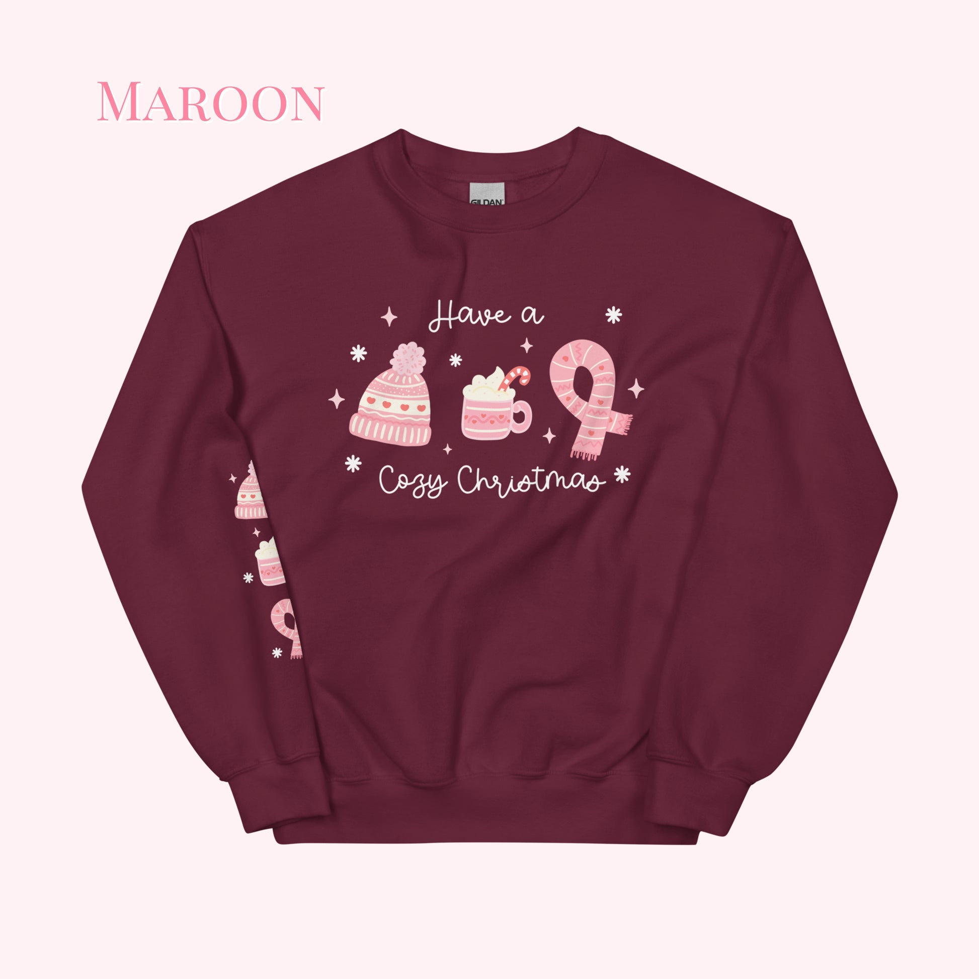 Maroon sweatshirt with pink Christmas-themed graphics and text on a white background